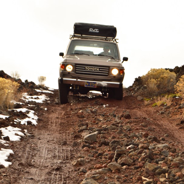 Toyota truck, roof-top tent, dirt road