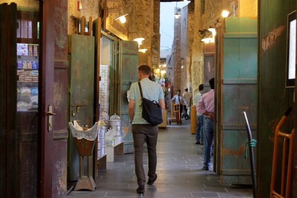 Man walking through outdoor market.